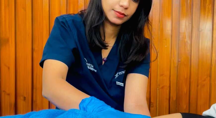 What Your C-Section Scar Tells You - Synchrony Chiropractic & Sports Physiotherapy - Chiropractor Near Me | Delhi | Noida | Chandigarh Close-up of a woman gently touching or examining her C-section scar area on her lower abdomen